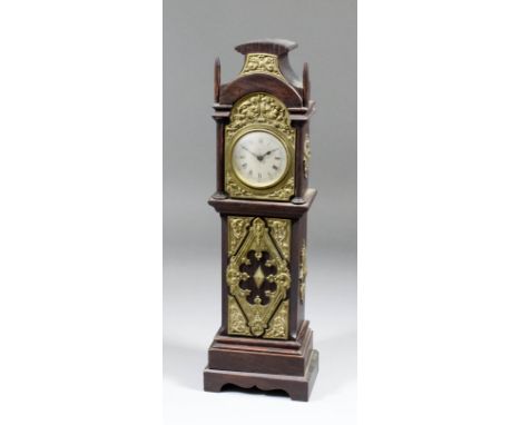 An early 20th Century oak and brass mounted miniature longcase timepiece, the 2.25ins diameter silvered dial with Roman numer