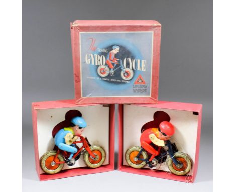 Two Triang giro cycles, one with red tinplate cycle frame and blue figure, the other with dark blue tinplate cycle frame and 