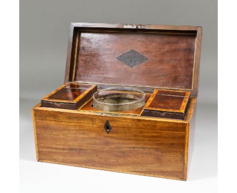 A late Georgian mahogany and crossbanded tea caddy of rectangular shape, the fitted interior with two caddies and glass mixin