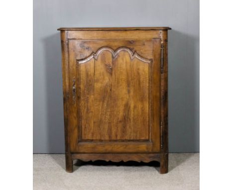 An 18th Century French oak dwarf cupboard with moulded edge to top and rounded front corners, fitted shelf enclosed by a sing