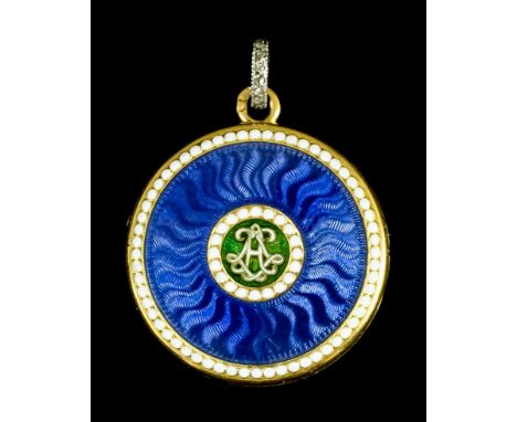 A Cartier gold and enamel locket of circular form, the face with guilloche blue enamel ground to central monogram within whit