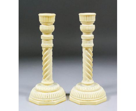 A good pair of 19th Century Anglo Indian engine turned ivory candlesticks, the spiral pattern column on a stepped base, 9.75i