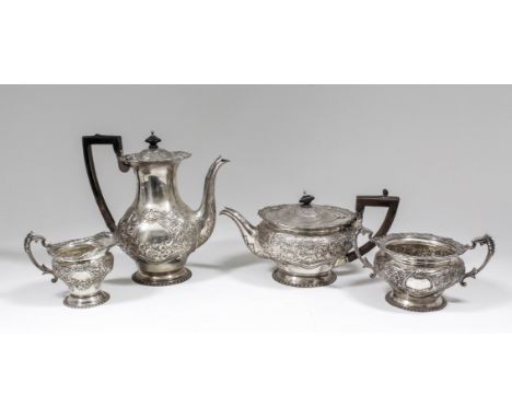 A late Victorian silver four piece tea and coffee service with floral and leaf cast mounts, the bodies embossed with floral, 