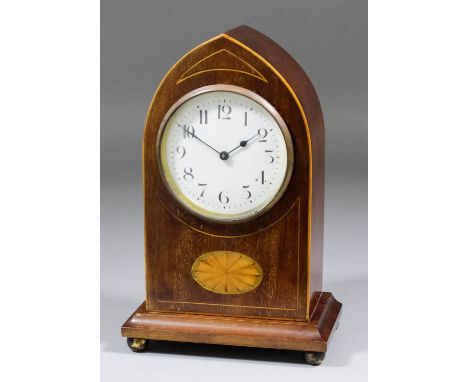 An Edwardian mahogany cased mantel timepiece, the 3.25ins diameter white enamel dial with Arabic numerals to the French movem