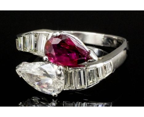 A modern silvery coloured metal mounted ruby and diamond cross-over ring, the pear cut ruby and pear cut diamond each approxi