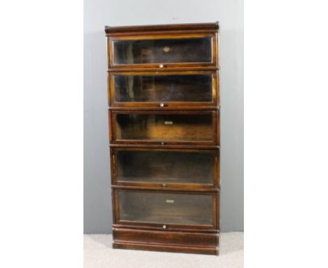 A Globe Wernicke oak five tier sectional bookcase, each tier enclosed by a rising glazed panel, on plinth base, 34ins wide x 