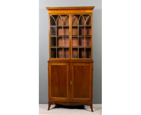 A mahogany bookcase of Georgian design, the upper part with moulded cornice inlaid with chequered banding, fitted three shelv