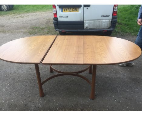 Ercol dining table of oval form with extra leaf (60cms) and four chairs 162 x 108 cms without leaf.