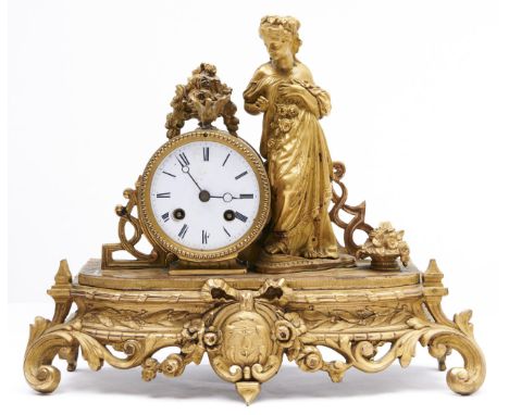 A French giltmetal mantle clock, late 19th c, in Louis XVI style, the cavetto base mounted with the figure of a maiden with r