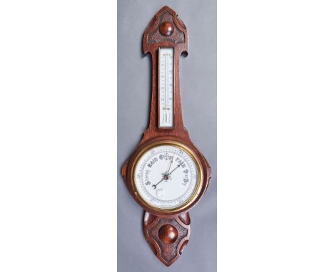 A carved oak aneroid barometer, early 20th c, with mercury thermometer, 85cm h, a 1930's Smiths oak mantel timepiece with ele
