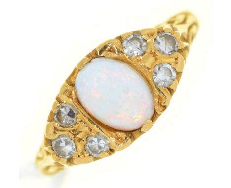 An opal and diamond ring, the larger central opal flanked by clusters of three evenly sized round brilliant cut diamonds to t