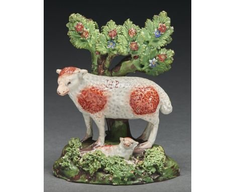 A Staffordshire pearl glazed earthenware group of a ewe and lamb, c1830, with overglaze painted enamel decoration, the sheep'