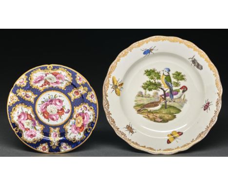 A Coalport scale blue ground plate, c1810, painted with groups of flowers and single blooms in gilt reserves, 18.5cm diam and