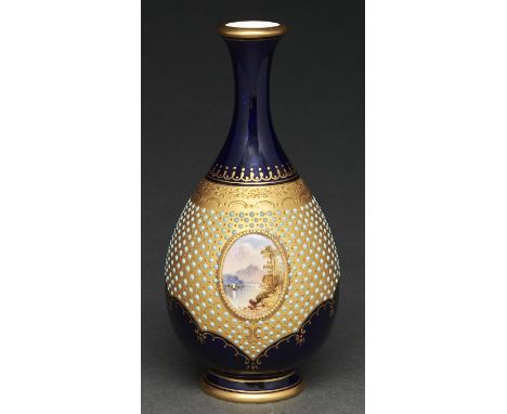 A Coalport jewelled vase, 1890-1926, painted with an oval landscape medallion reserved on a jewelled gilt apron and cobalt gr