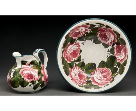 A Wemyss ware chamber jug and basin, c1900, painted with roses, basin 29cm diam, impressed mark, the basin with printed oval 