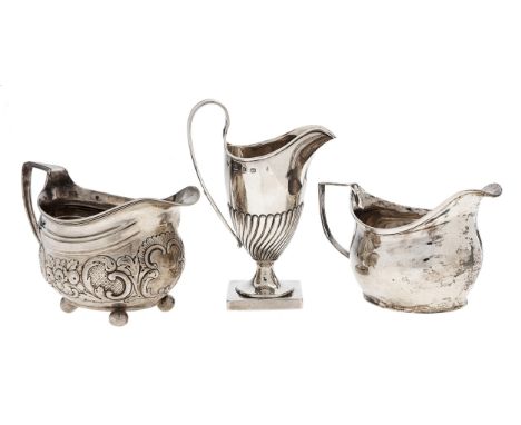 A George III silver cream jug, 75mm h, marks rubbed, London 1810, another later chased, London 1814 and a helmet shaped silve