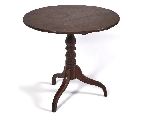 A George III oak tripod table, the tip-up top on elm block, turned pillar and downcurved legs, 72cm h; 78cm diam  Fair condit