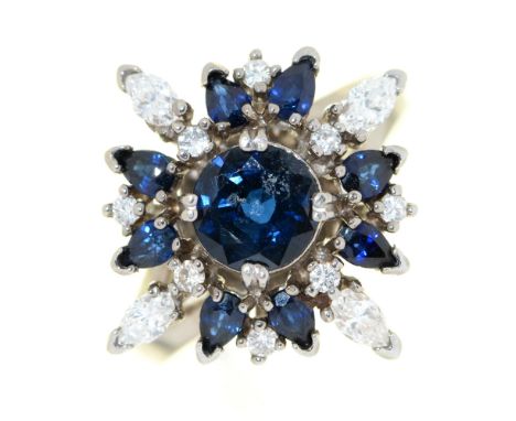 A sapphire and diamond cluster ring, &nbsp;the larger central sapphire and smaller evenly sized round brilliant cut diamonds 