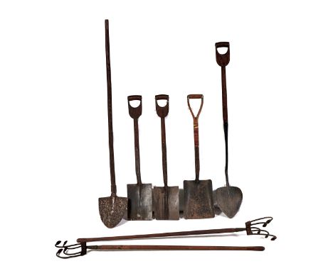 A group of bygone garden tools, several late 19th or early 20th c, including two turfing irons, two spades, a shovel and two 