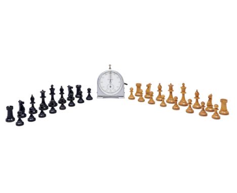 A Staunton pattern chess set, boxwood and ebonised, early 20th c, the knights with glass eyes, kings 85mm h, in mahogany box 