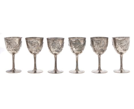 A set of six Chinese silver goblets, early 20th c, the ovoid bowl applied with dragon and pearl, 80mm h, marked SILVER, 6ozs 