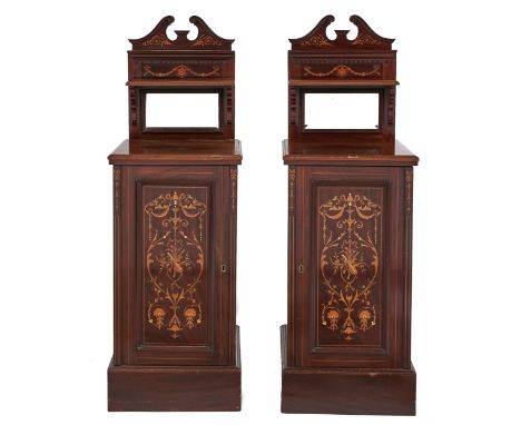 A pair of Edwardian mahogany and inlaid pedestal pot cupboards, the bevelled mirror inset superstructure with swan neck pedim