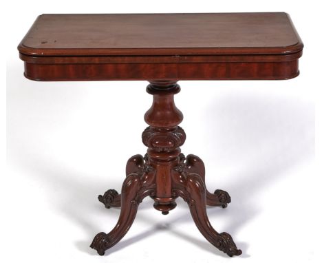 A Victorian mahogany tea table, the baluster pillar with carved bulbous knop and quadruple legs with cabochon knees and feet,