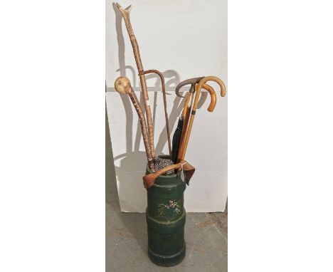 A green painted fabric cylindrical Fire Water bucket with leather handle, the body bearing partial transfer printed crest, 53