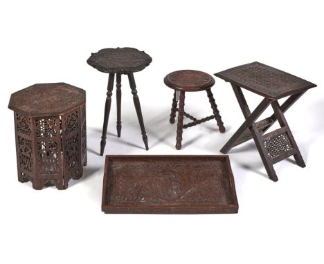 Three Indian carved hardwood tripod and coffee tables, including a folding table, early 20th c and a similar gallery tray, va