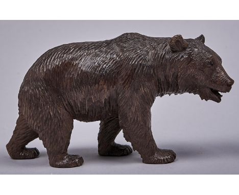 A Swiss stained limewood carving of a bear, early 20th c, black button eyes, 11cm h  A good example, not cracked or chipped