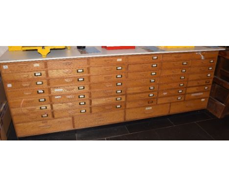 *Chest of drawers. A large 20th century 'shop counter style' chest of drawers (with contents), with white melamine work top, 