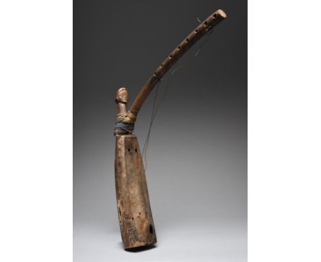 A Tsogho harp Gabon with a carved head finial, having elliptical eyes and a crescent forehead band, with a vellum skin and fi