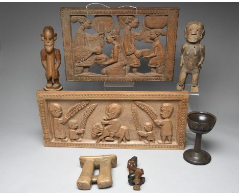 A South African colon figure with a moustache and wearing an overcoat with burnished highlights, 27.5cm high, a West African 