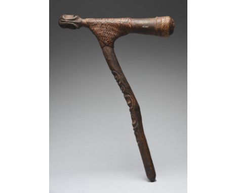 A Sepik River adze Papua New Guinea the handle with five carved masks, one being janus, to a janus head finial, rattan bound 