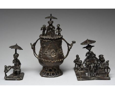 An Ashanti kuduo Ghana brass, the cover with five figures and the curved ladder side handles with a further two, 23.5cm high,