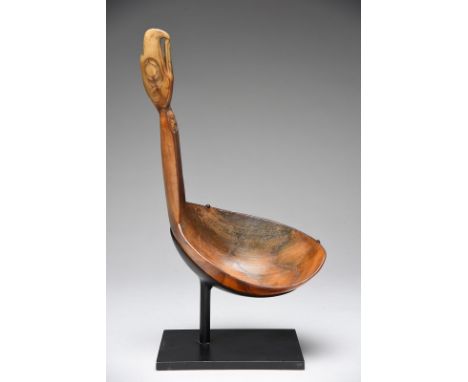A Tshimshian ladle Northwest Coast North America sheep horn, with a deep ovoid bowl and a tapered handle with a carved human 