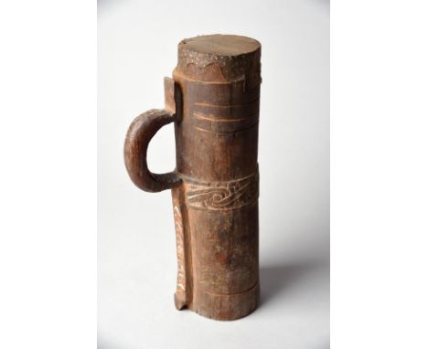 A Massim drum Trobriand Islands with carved decoration having remains of red/orange and white pigment, with an integral handl