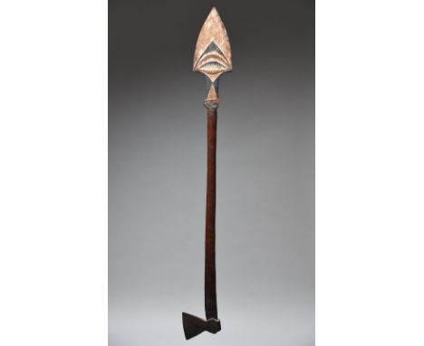 A New Ireland / New Britain axe Papua New Guinea with a spear like finial with carved stylised decoration and remains of whit