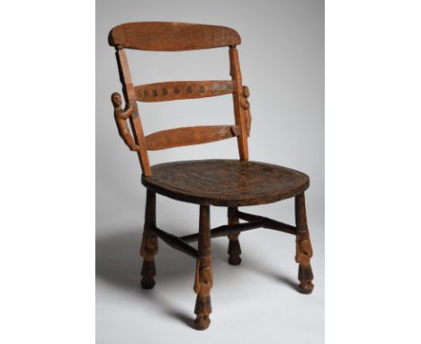 A Bembe chair Democratic Republic of the Congo the ladder back with carved geometric decoration and a pair of figures to the 