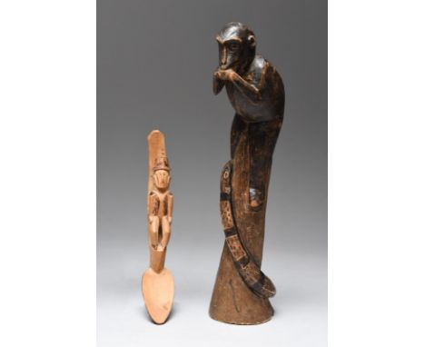 A Rotse group Zambia carved a monkey on top of a trunk eating a fruit with a snake entwined around the trunk, with scorched d