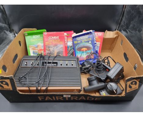 Atari: a vintage 2600 console; together with controllers and five related boxed games. 