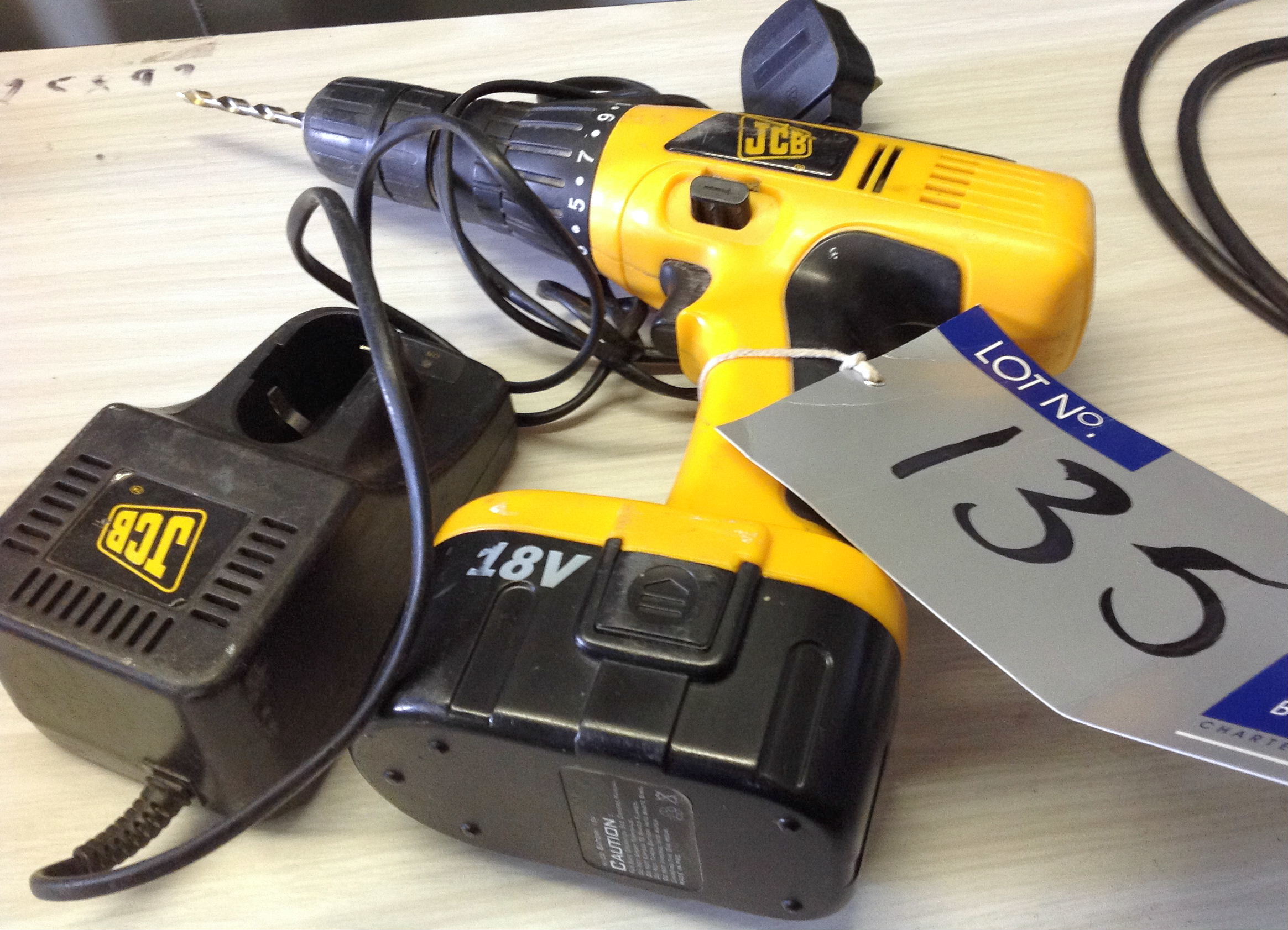 A JCB JCBDCD18C Cordless Drill and Charger.