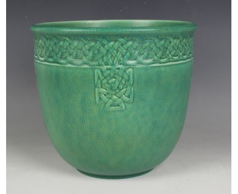 A Pilkington's Royal Lancastrian matt green glazed jardinière, 1930, of U-shape with a Celtic knot type band relief moulded t