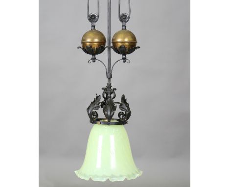 A late Victorian Arts and Crafts wrought iron and gilt brass rise-and-fall ceiling light, fitted with a large Powell type vas