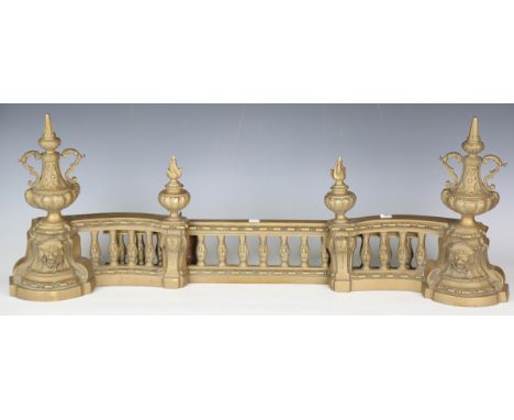 A 19th century French brass adjustable fender, the central panel flanked by a pair of urn chenets, height 33cm, unextended wi