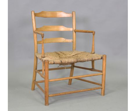 A late Victorian Arts and Crafts ash framed Sussex armchair, possibly Morris &amp; Co or Ernest Gimson, the shaped ladder bac