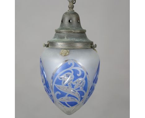 An Edwardian Arts and Crafts blue flashed and frosted glass ceiling light, the brass cap supporting an ovoid shade cut with p