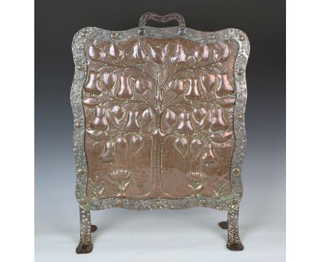 An Edwardian Arts and Crafts patinated copper and steel framed 'Tree of Life' firescreen by John Pearson, the shaped panel re
