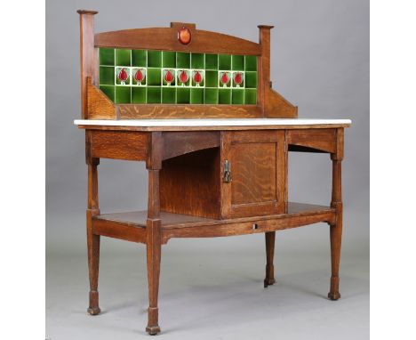 An Edwardian Arts and Crafts oak washstand by Shapland &amp; Petter of Barnstaple, the tile back inset with a Ruskin glazed p