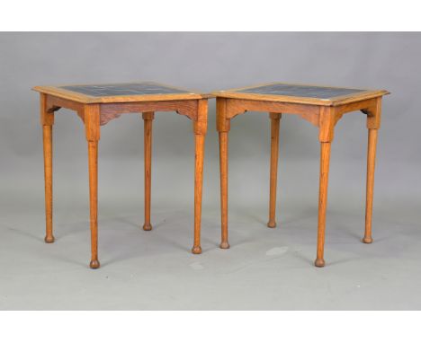 A pair of Edwardian Arts and Crafts oak tile-topped occasional tables, in the manner of William Birch, height 72cm, width 61c